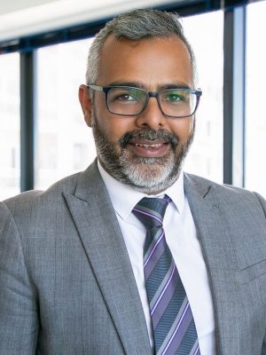 content-indian-ceo-standing-smiling-portrait-successful-pensive-bearded-businessman-glasses-posing-office-room-business-expression-management-concept_74855-11642